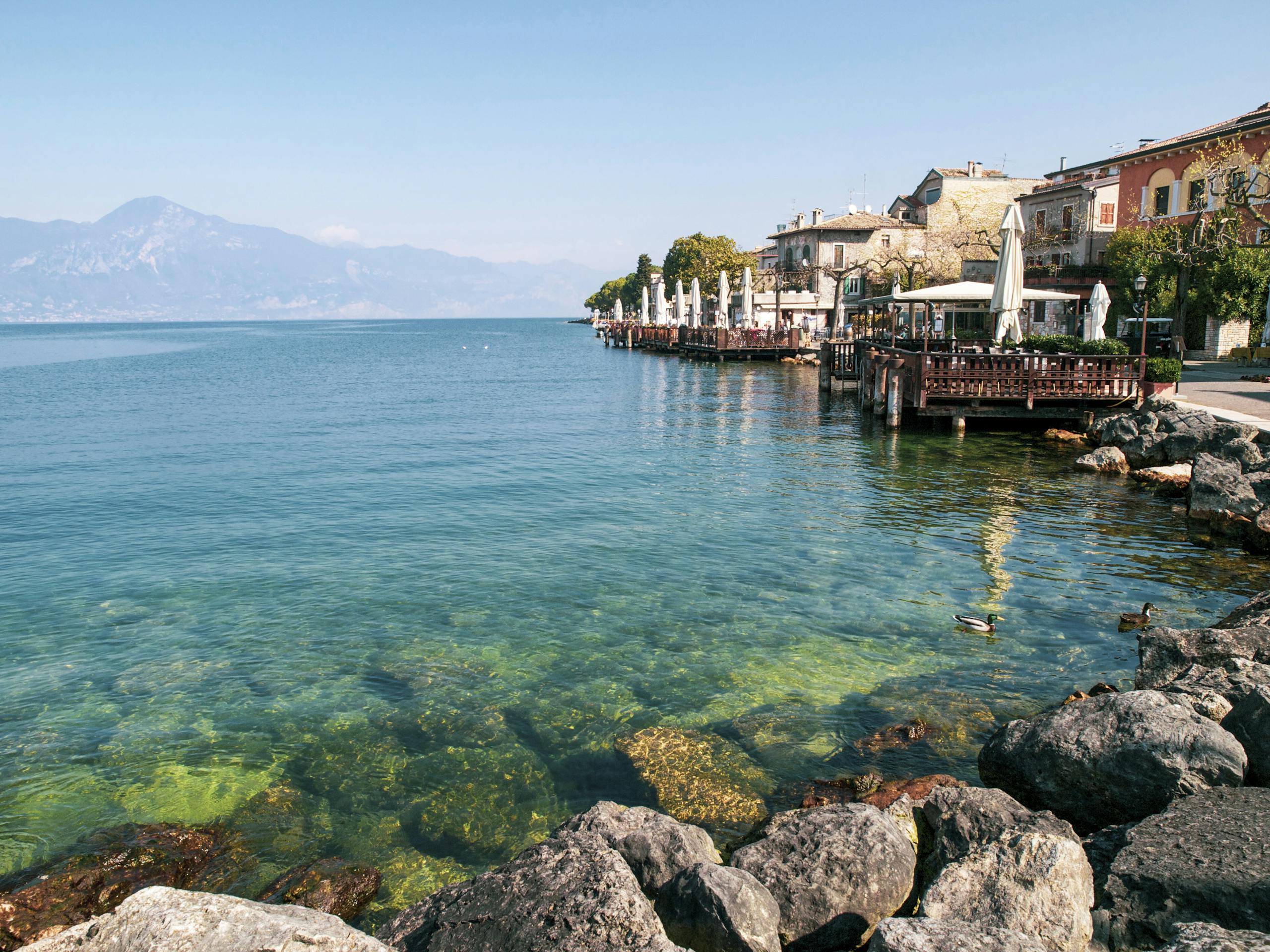 Clear Sea Water in Beach With Cottages