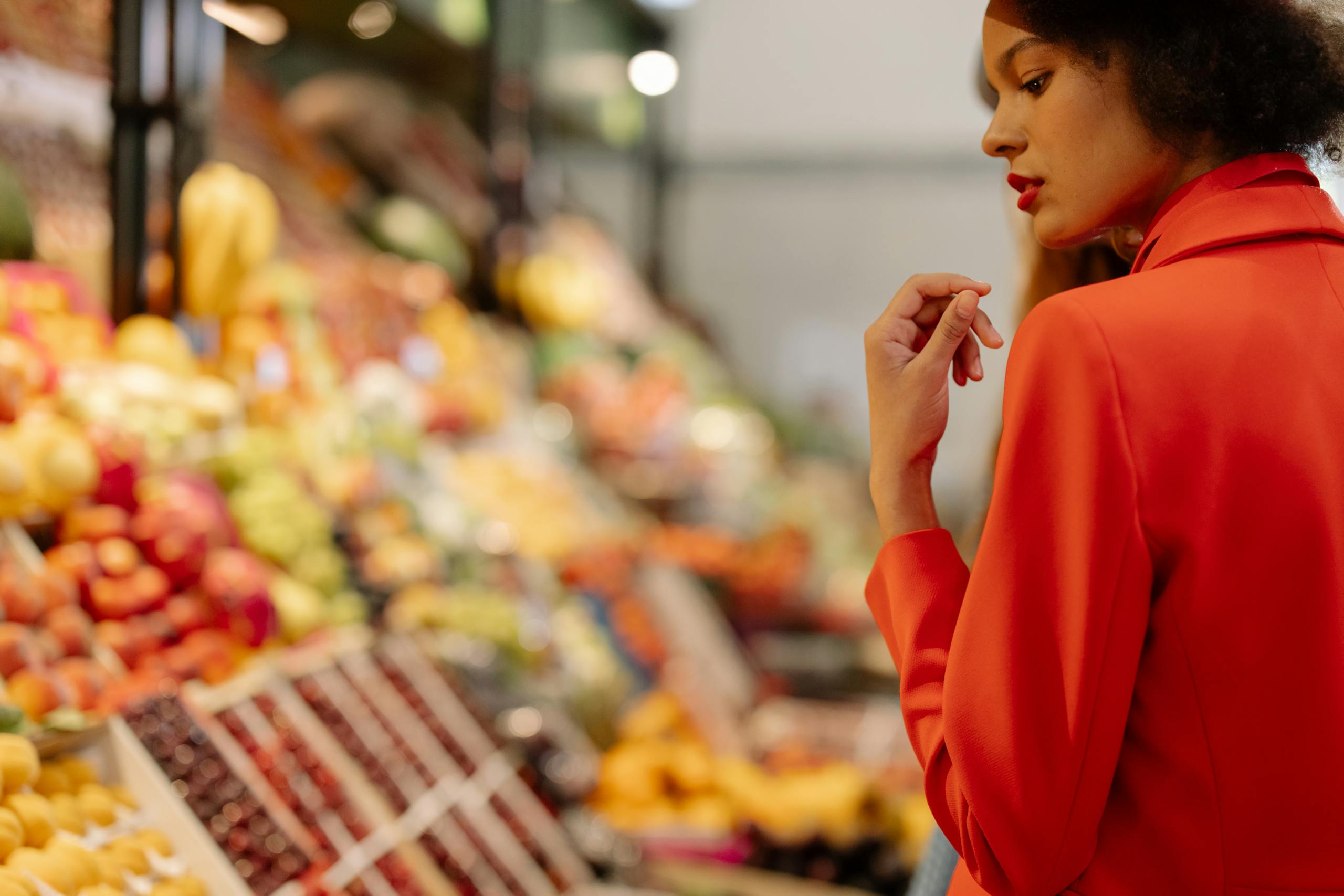 Beautiful Woman in red Jacket Standing Near the Fruits Stand Hrana