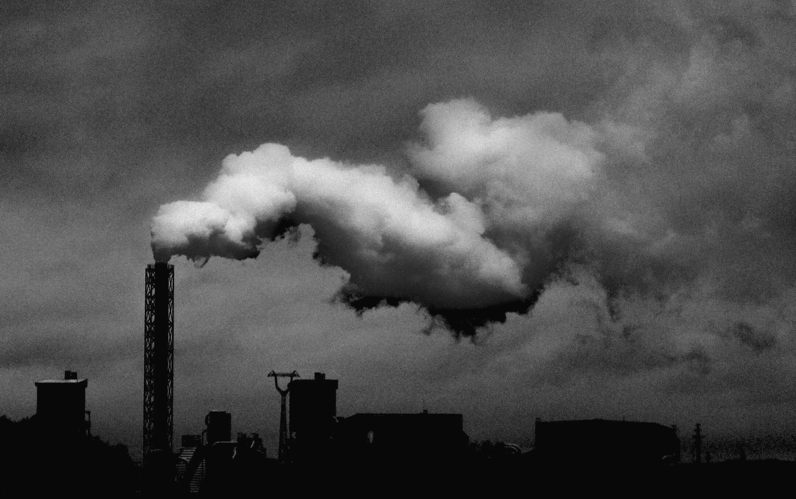 Black and white image of factory emissions illustrating industrial pollution.