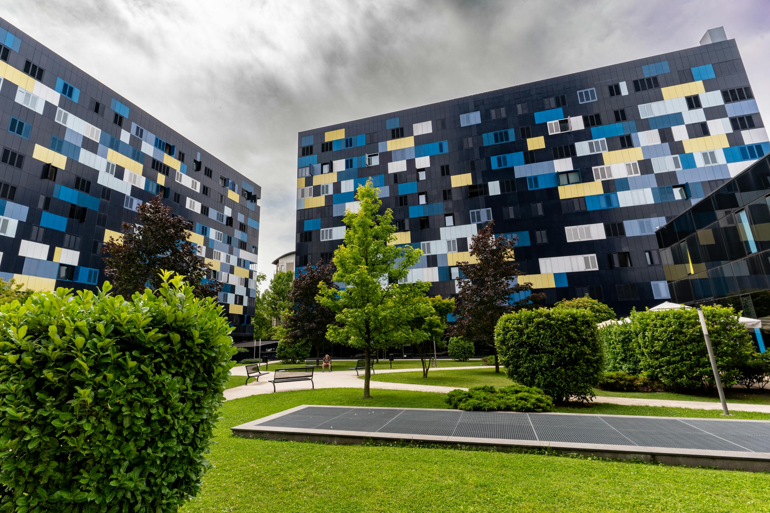 Colorful facade buildings in a green park area, showcasing modern design in Zagreb, Croatia.
