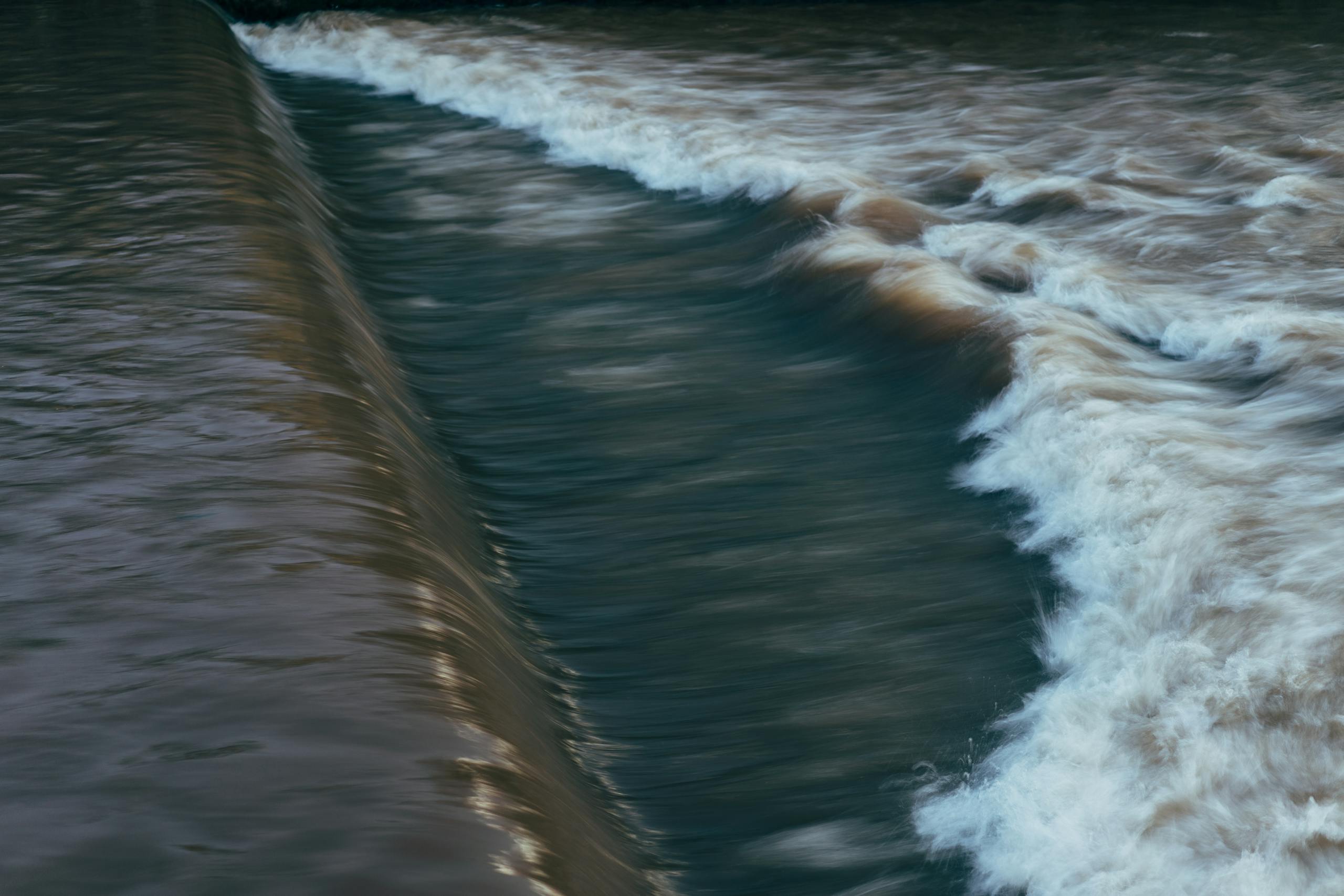 Captivating view of water flowing over a dam in Sarajevo, Bosnia and Herzegovina.