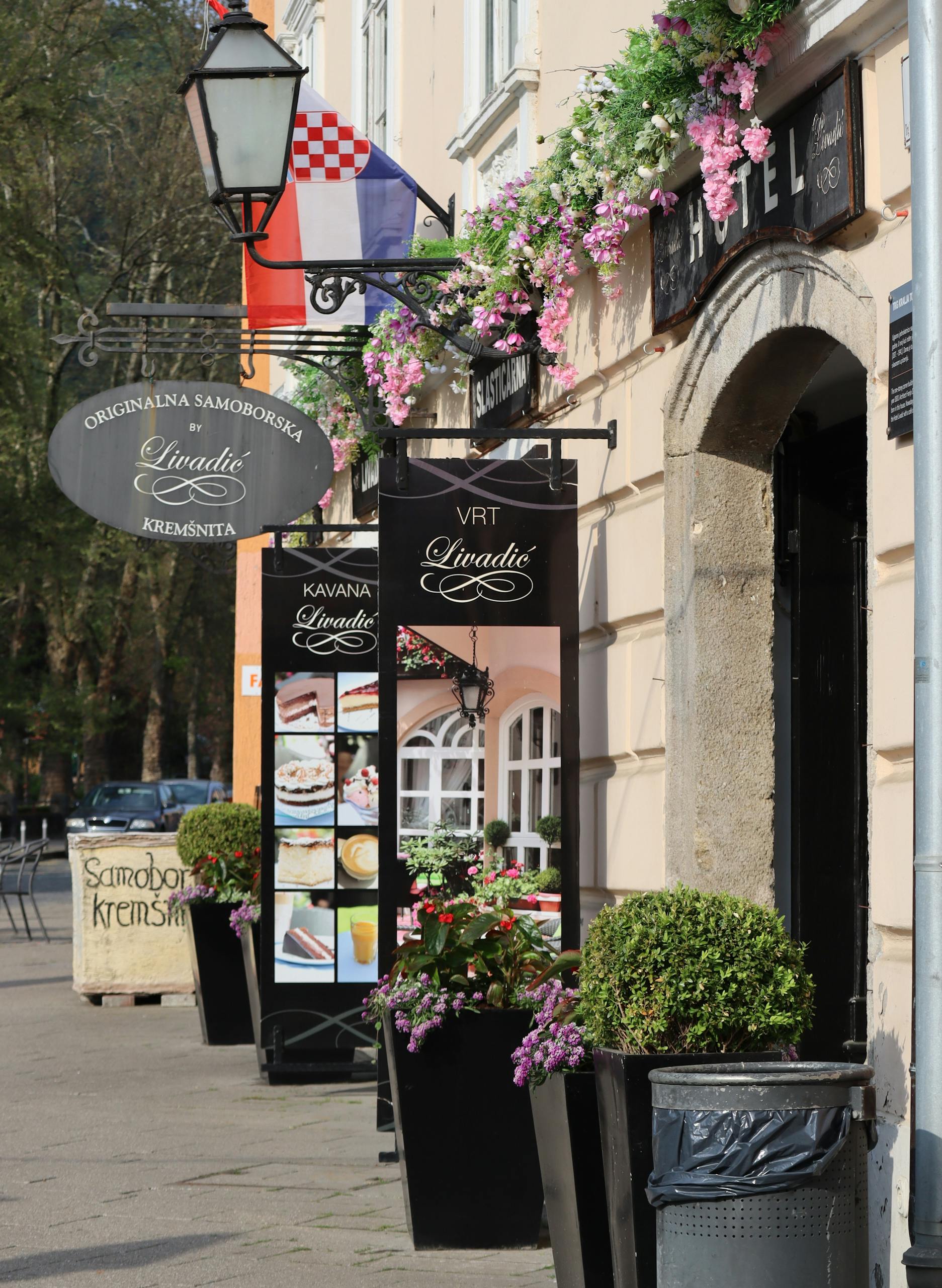 Delightful exterior of a Croatian cafe adorned with flowers. Perfect for exploring local culture.