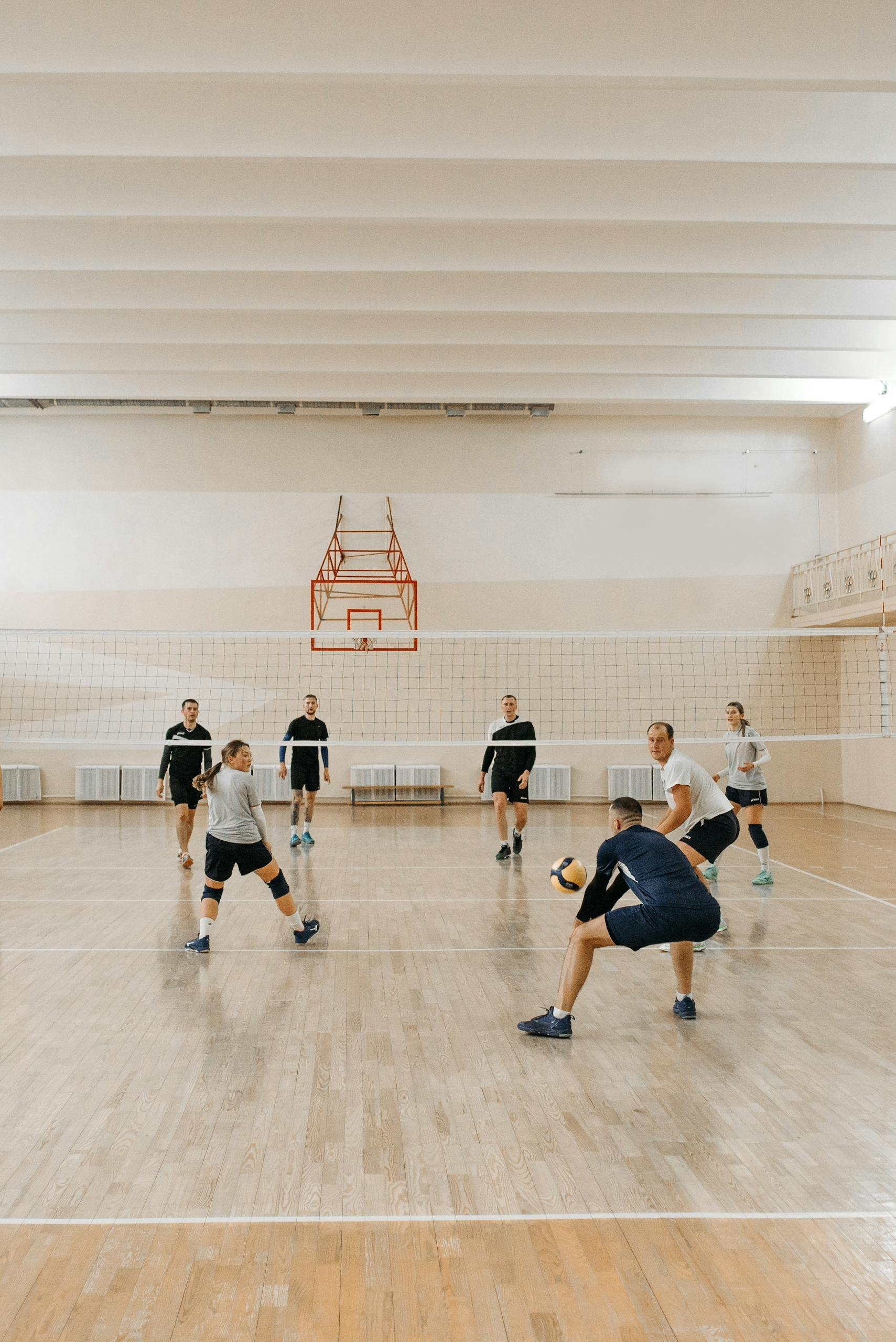 Energetic players engaged in a competitive indoor volleyball game.